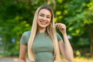 smiling woman and aligner orthodontics concept